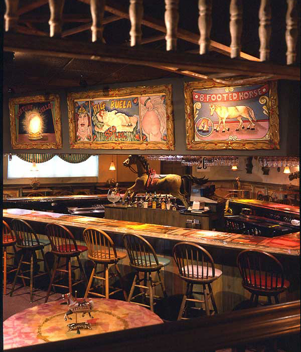 Rollick's carnival restaurant-bar with table top kinetic displays, hand-painted vintage circus posters for live jazz lovers. Classic carnival restaurant style with festive surprising animated art designed by Carolyn Robbins Interiors