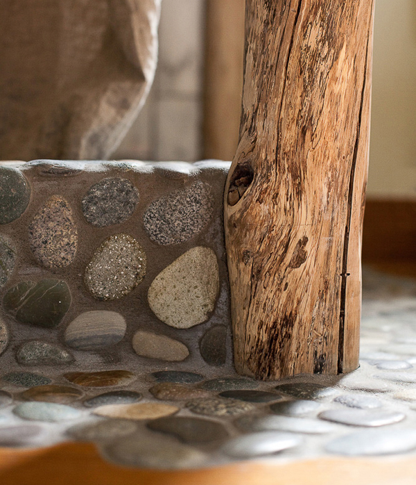 Reconstructed bathroom using river stones and reuse tiles. Marine Green Interior designed by Carolyn Robbins