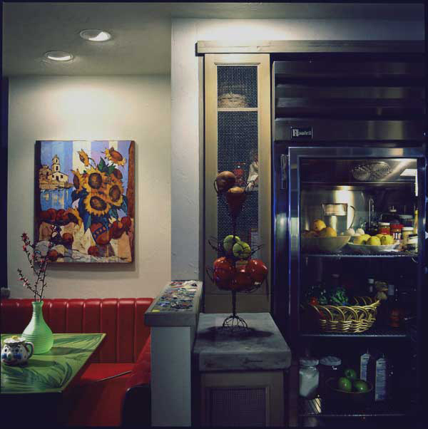 Natural enhancements using coral stone, mosaic and reuse wood cabinets and furnishings designed by Carolyn Robbins