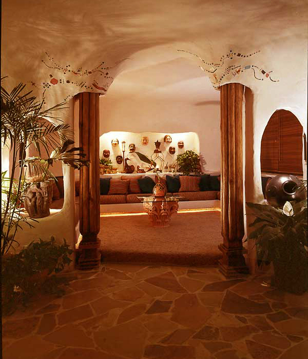 urton Goldberg’s penthouse interior in plaster arched ceilings and cave like alcoves, illuminates his primitive art collection interior design by Carolyn Robbins