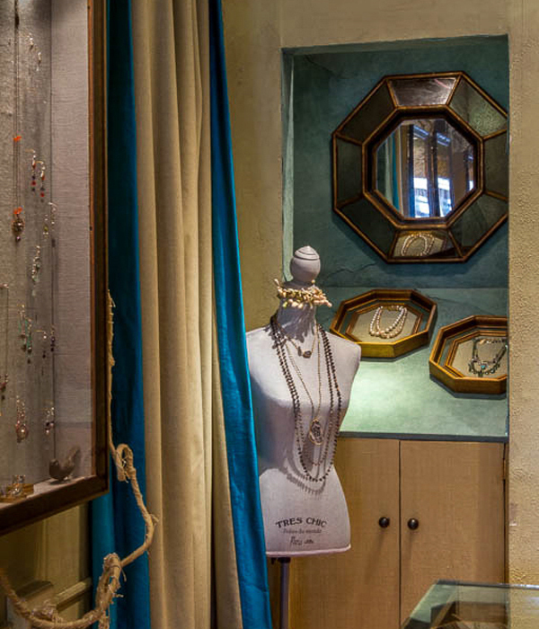Classic wall cases lined in velvet with unique application of wrapped electrical wires - Interior design by Carolyn Robbins
