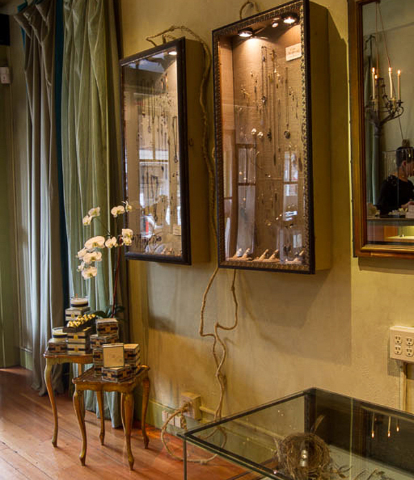 Classic wall cases lined in velvet with unique application of wrapped electrical wires - Interior design by Carolyn Robbins