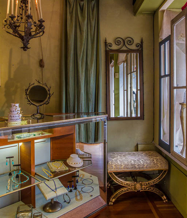 Classic wall cases lined in velvet with unique application of wrapped electrical wires - Interior design by Carolyn Robbins