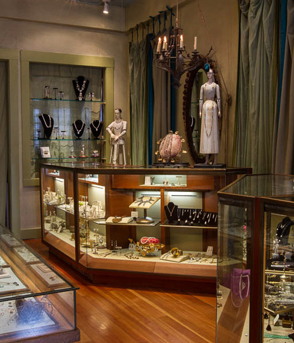 Classic wall cases lined in velvet with unique application of wrapped electrical wires - Interior design by Carolyn Robbins