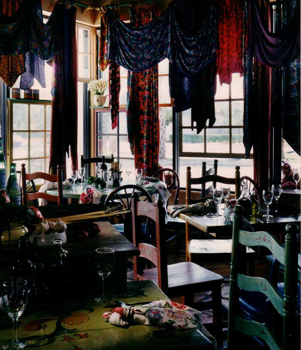 Tutti's Italian market design by Carolyn Robbins, combines repurposed wood, gypsy style use of fabric patterns, for vintage kitchen charm.