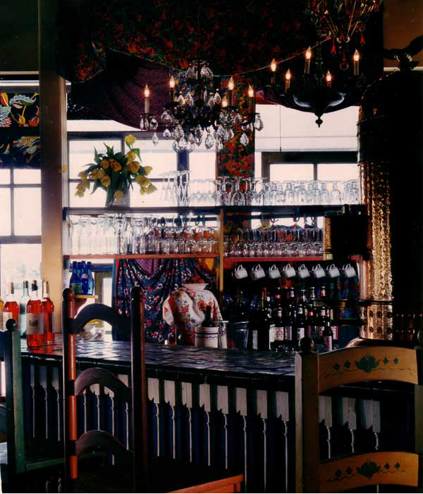 Tutti's Italian market design by Carolyn Robbins, combines repurposed wood, gypsy style use of fabric patterns, for vintage kitchen charm.