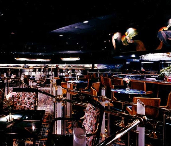 80’s dance club with lit lucite, jungle wall murals and aurora bar lighting - Banana Max nigtht Club interior designed by Carolyn Robbins