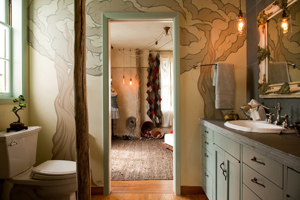 Reconstructed bathroom using river stones and reuse tiles. Marine Green Interior designed by Carolyn Robbins