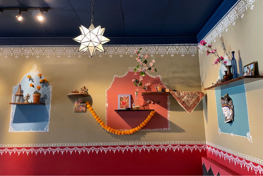 Indian decor using festive feel with hand stenciling in bright color - Avatar’s interiors designed by Carolyn Robbins