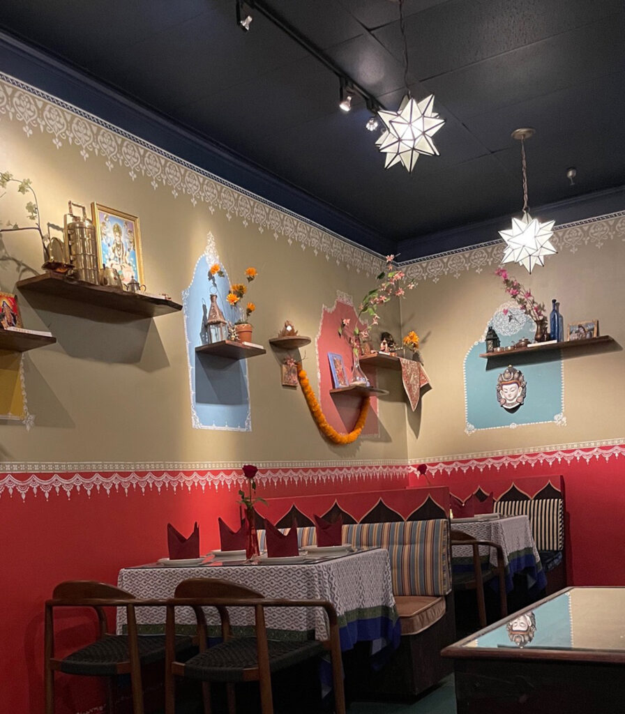 Indian decor using festive feel with hand stenciling in bright color - Avatar’s interiors designed by Carolyn Robbins