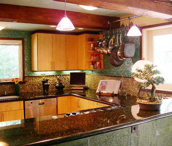 Noted kitchen interior blending sustainable bamboo, river rock, reflective dark granite and aqua glass tile for Japanese inspired seaside interior designed by Carolyn Robbins
