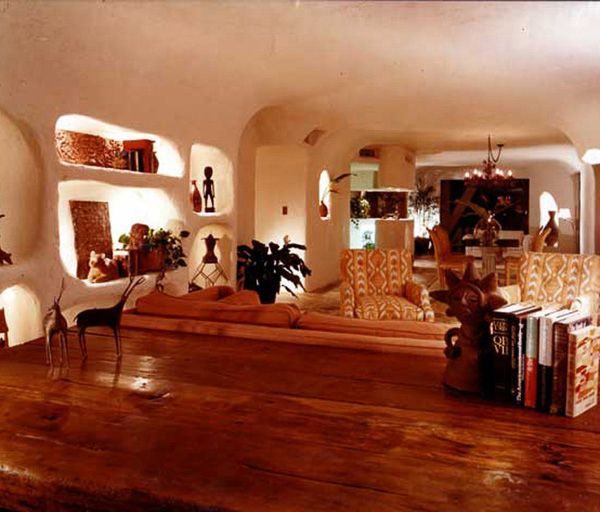 urton Goldberg’s penthouse interior in plaster arched ceilings and cave like alcoves, illuminates his primitive art collection interior design by Carolyn Robbins
