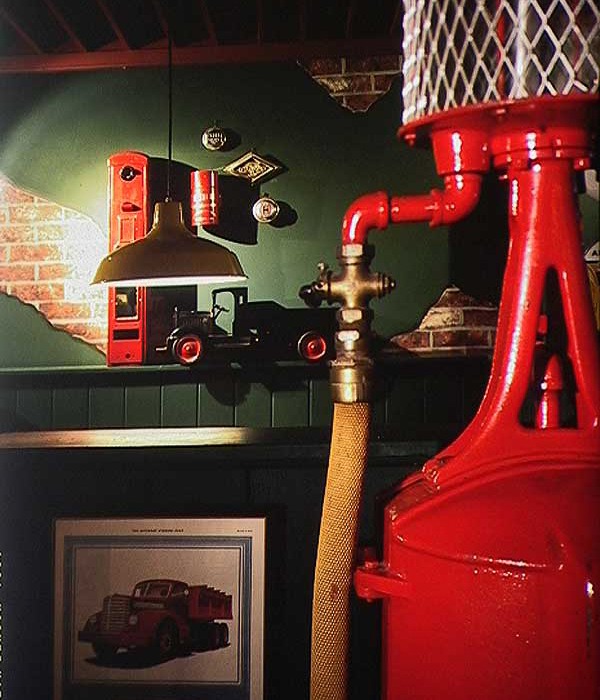 Whitney’s auto-style interior by Carolyn Robbins, features refurbished gasoline pumps, repurposed car-parts and garage pendent lighting.
