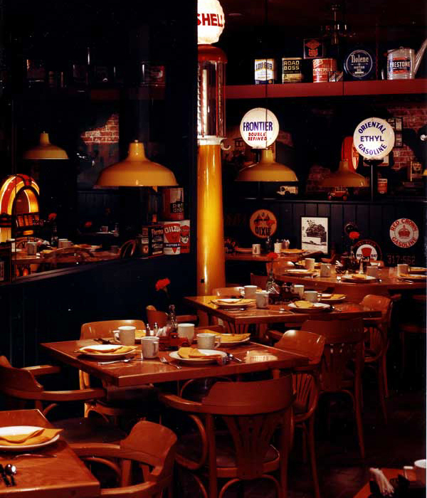 Whitney’s auto-style interior by Carolyn Robbins, features refurbished gasoline pumps, repurposed car-parts and garage pendent lighting.