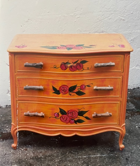 Provincial dresser ornamented with handprinted roses and tree-branch hardware by Carolyn Robbins